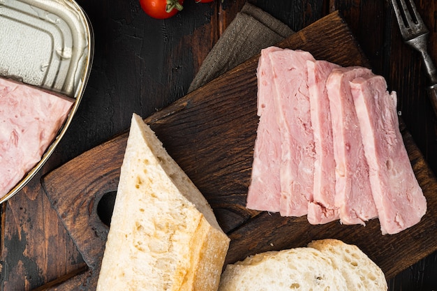 Canned ham sandwich set, on old dark  wooden table background, top view flat lay