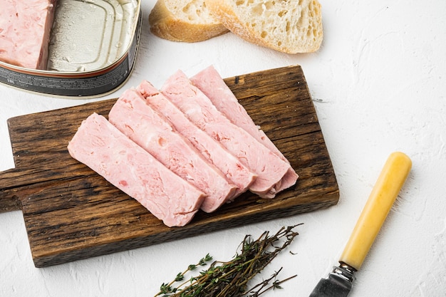 Canned ham slices sandwich on white stone table background