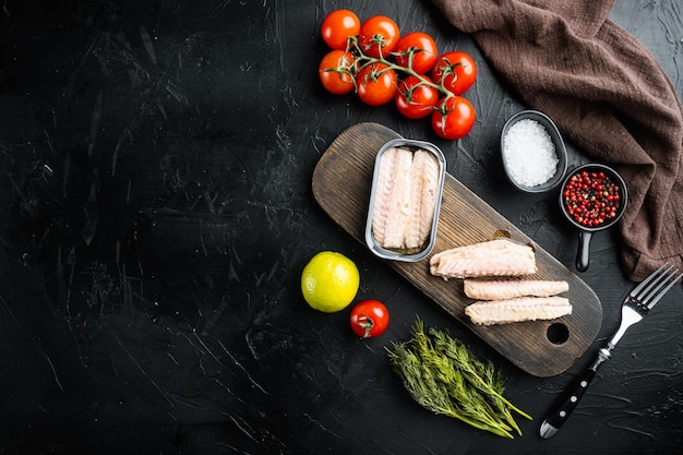 Canned Mackerel  fillet, fish preserves set, on wooden cutting board, on black