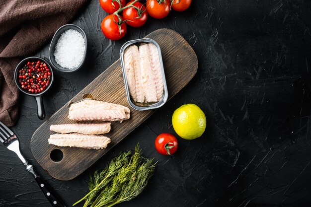 Canned Mackerel Fillets in Tin set, on wooden cutting board, on black