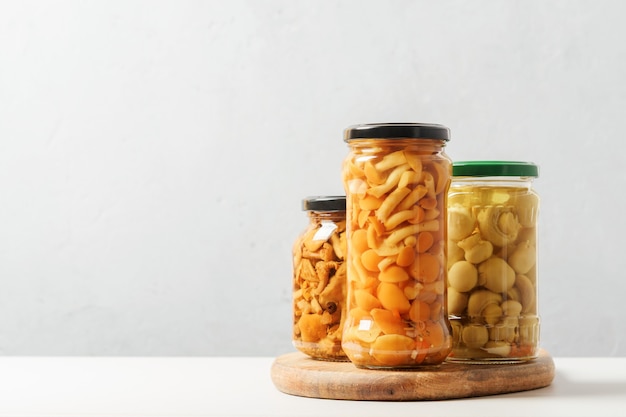 Canned mushrooms in cans on a concrete background with copies of space.