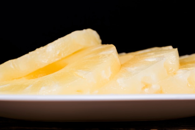 Canned pineapple cut into slices, canned ripe pineapple with sweet sugar syrup