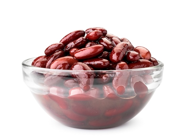 Canned red beans in a glass plate close-up on a white background