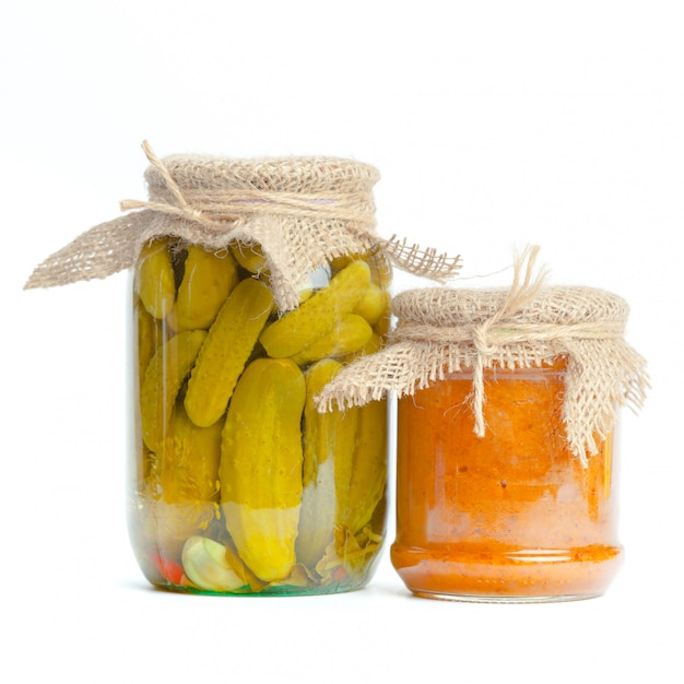 Canned vegetables in glass jars isolated on white background