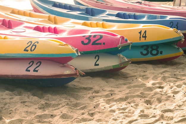 Canoes are stacked on the beach.