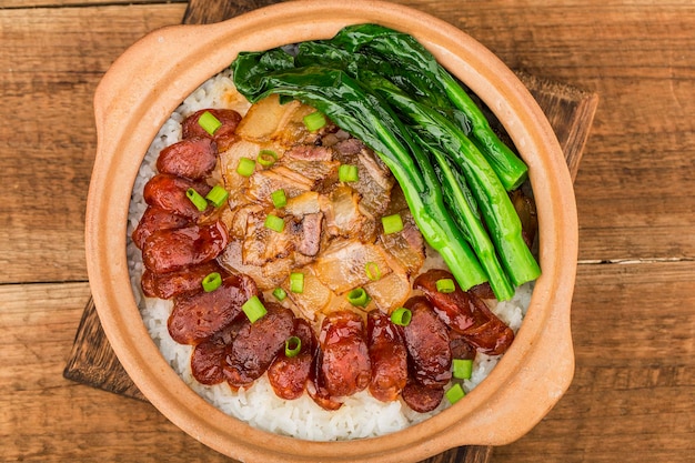 Cantonese style cooking of claypot rice with waxed meats