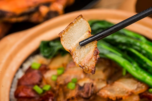 Cantonese style cooking of claypot rice with waxed meats