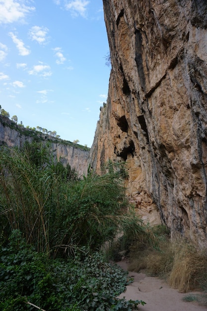 The canyon wall is a natural rock formation.