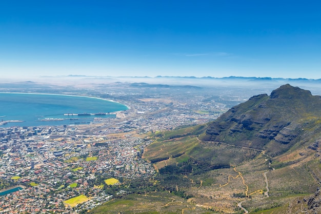 Cape Town and mountains in fog view from Table Mountain top