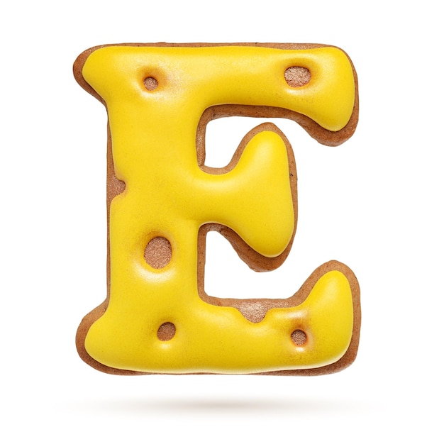 Capital letter E yellow homemade gingerbread biscuit isolated on white background