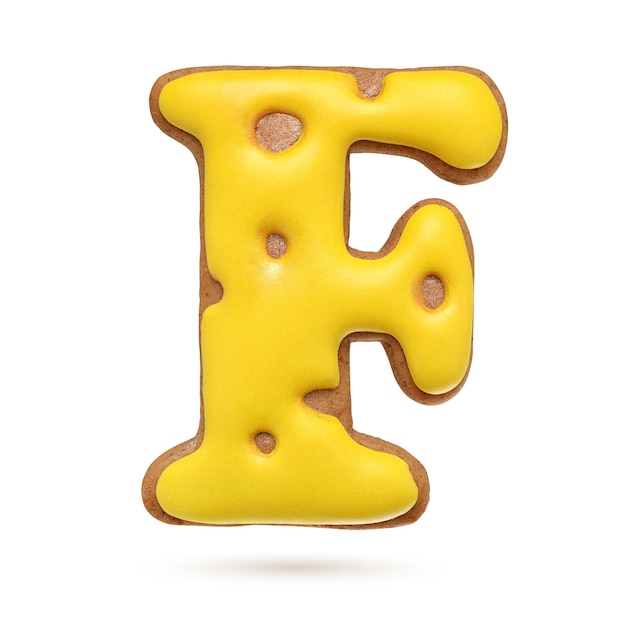 Capital letter F yellow homemade gingerbread biscuit isolated on white background