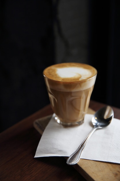 Cappuccino coffee on wood background