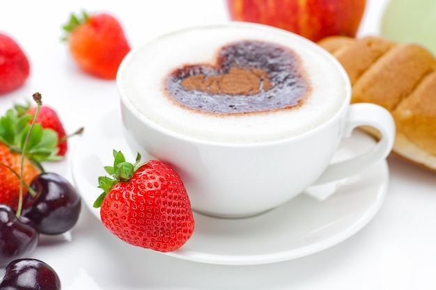 Cappuccino in a cup in the shape of hearts, cherry, croissant and