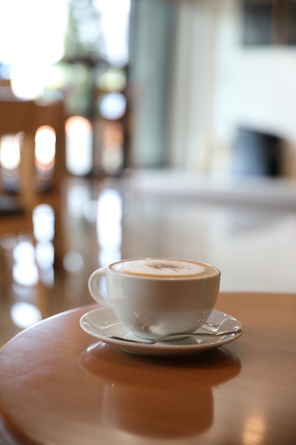 Cappuccino or Latte art coffee made from milk on the wood table in coffee shop