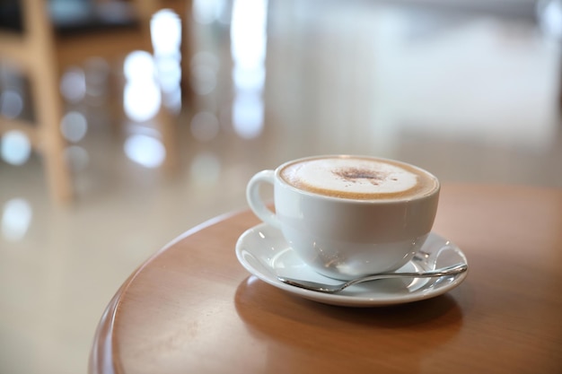 Cappuccino or Latte art coffee made from milk on the wood table in coffee shop