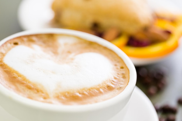 Cappuccino with fresh cranberry orange scone for breakfast.