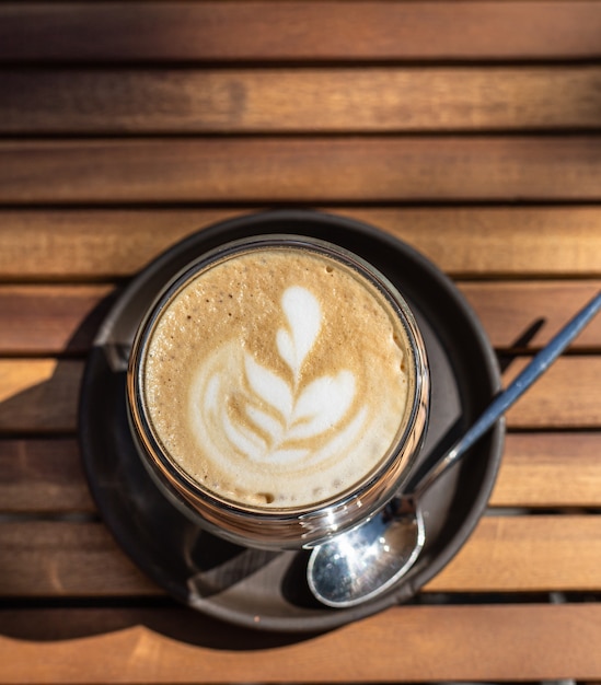 cappuccino with latte art in outdoor cafe or coffeehouse selective focus sunny morning