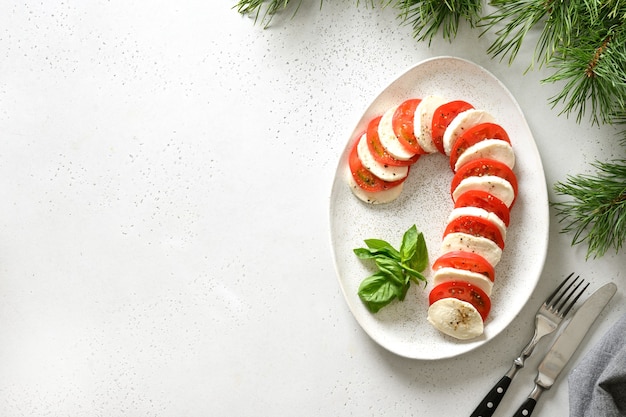 Caprese candy cane holiday appetizer on Christmas served white table