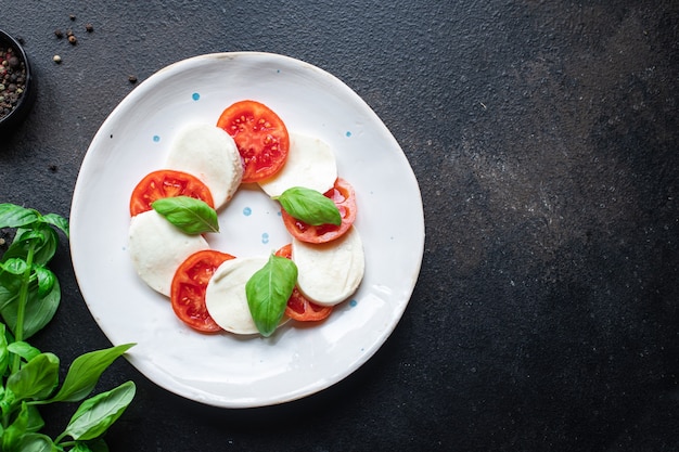 Caprese salad mozzarella cheese tomato basil leaf italian snack copy space food background rustic