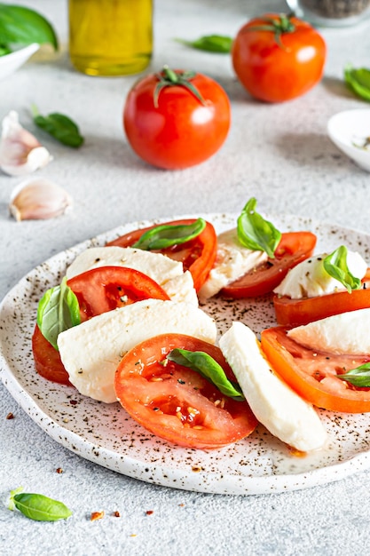 Caprese salad with juicy tomatoes fresh mozzarella and pesto Concept for a tasty and healthy appet