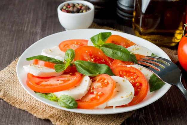 Caprese salad with tomatoes, basil, mozzarella cheese. 