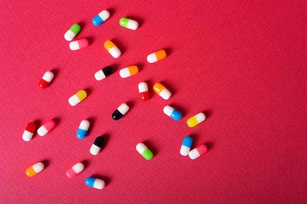 Capsules tablets multicolored on the background of magenta color