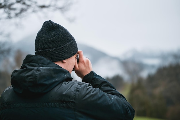 Capturing Alpine Beauty Man Photographer Capturing professional images of SnowCapped Peaks in Wanderlust Moment Concept of vacation in Europe