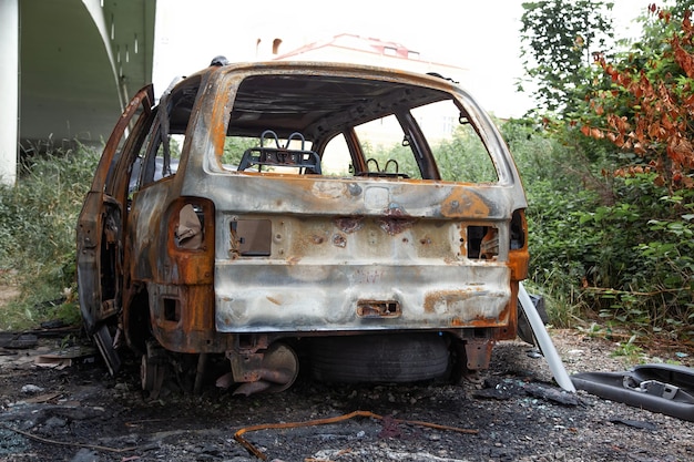 Car after a fire Burnt rusty car after fire or accident Car after the fire crime of vandalism riots Arson car Accident on the road due to speeding Explosion