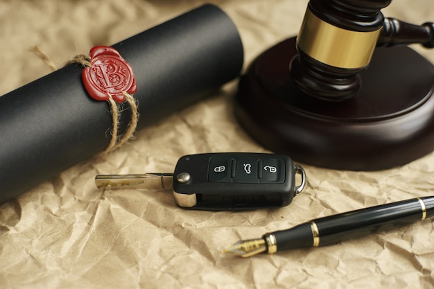 Car auction concept - gavel and car key on the wooden desk