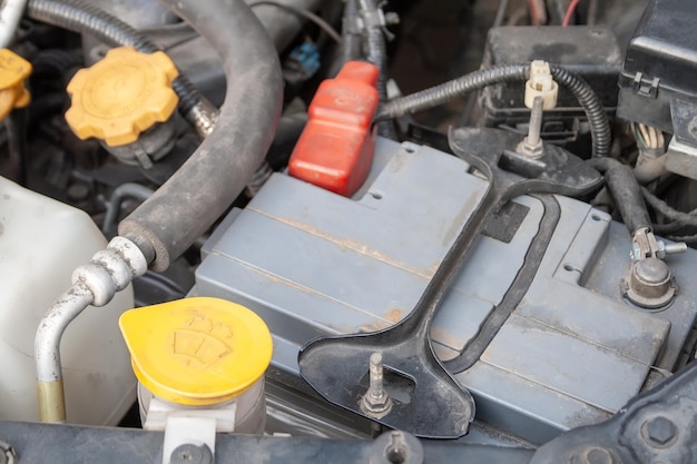 Car battery and windshield washer close up detail of a flatfour boxer car engine compartment under t...