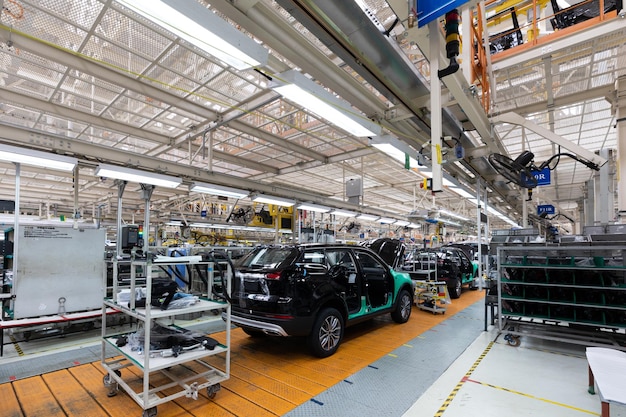 Car bodies are on assembly line factory for production of cars modern automotive industry a car