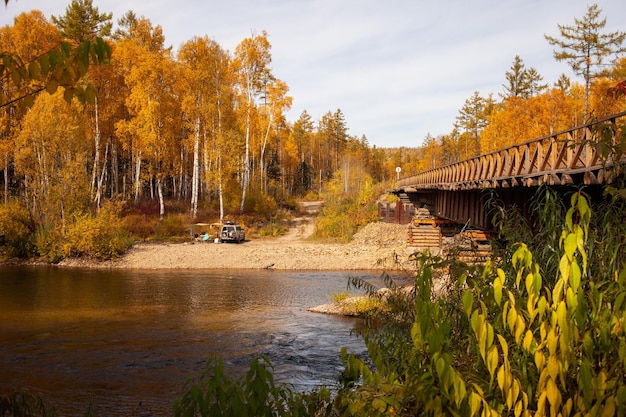 Car camping at mountain river in autumn