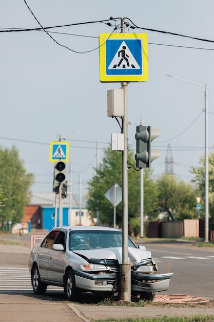 The car crashed into a pole at a crosswalk