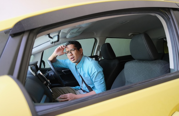 A car driver showing confused expression