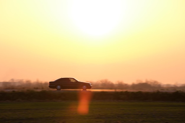 Car driving fast on intercity road at sunset Highway traffic in evening