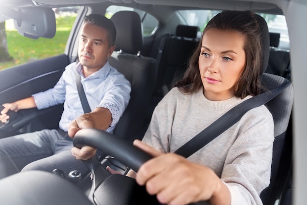 car driving school instructor teaching woman