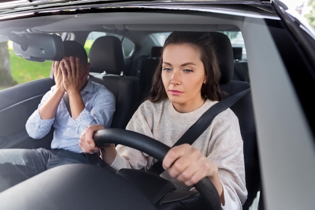 car driving school instructor teaching woman