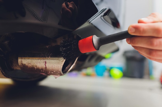 Car exhaust pipe with soap Car wash background brushing