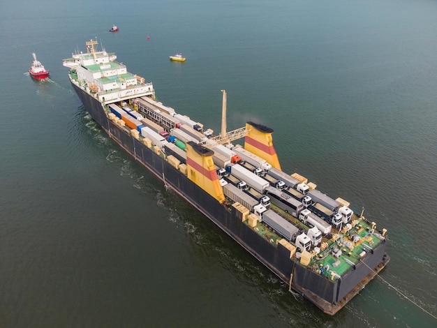 Car ferry boat transports trucks in the sea aerial view