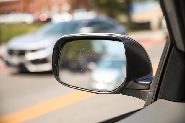 A car is parked on the street in front of a car.