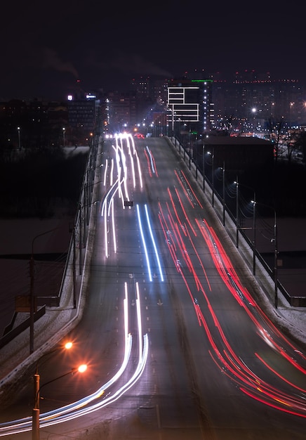 The car light trails on the highway in the night modern city