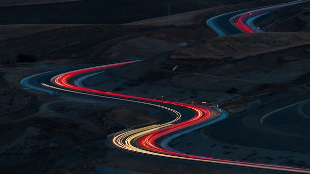 Car lights at night on the mountain pass winding road