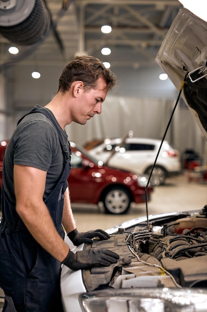 Car mechanic in doing auto repair service and maintenance worker repairing vehicle service and maint...