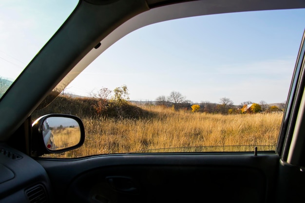 Car mirror and highway view, black car and nature landscape in Georgia