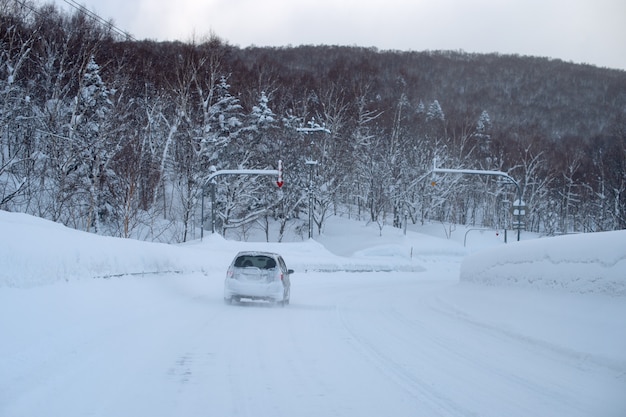 Car on a mountain road in a snowy day