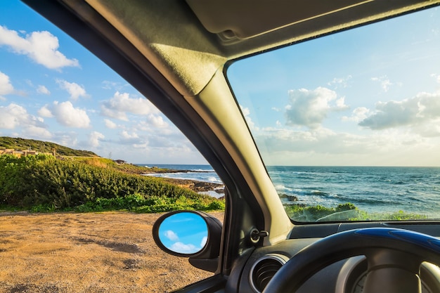 Car parked by the sea on a cloudy day