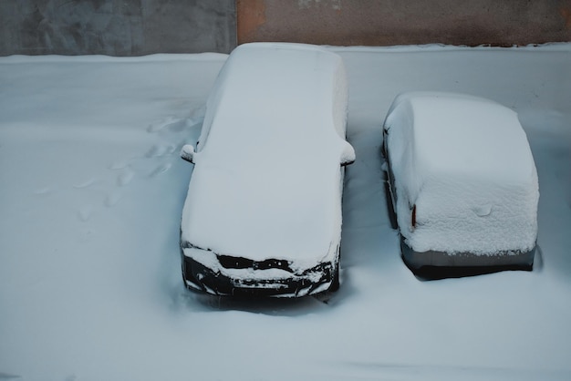 A Car Parked On The Street And Completely Covered With Snow Heavy Snowfall Weather Concept Of Glob