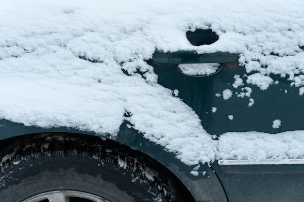 Car parts covered with snow and ice after a snowfall Big frosts and a lot of snow in the city Problems on winter slippery roads