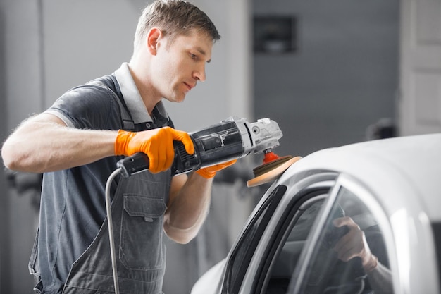 Photo car polishing in auto repair shop closeup image vehicle detailing