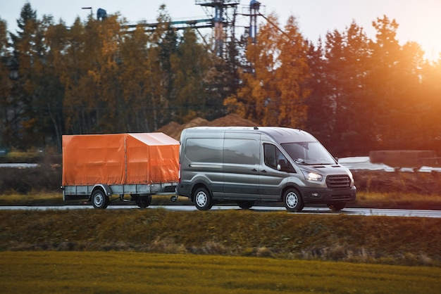 A Car and a Rental Trailer on a Curvy Road A Smart Way to Move Your Stuff Transporting Cargo with a Car and a Trailer A Convenient and CostEffective Solution